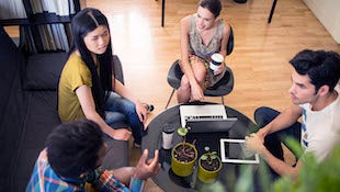 Four young business people on a meeting.